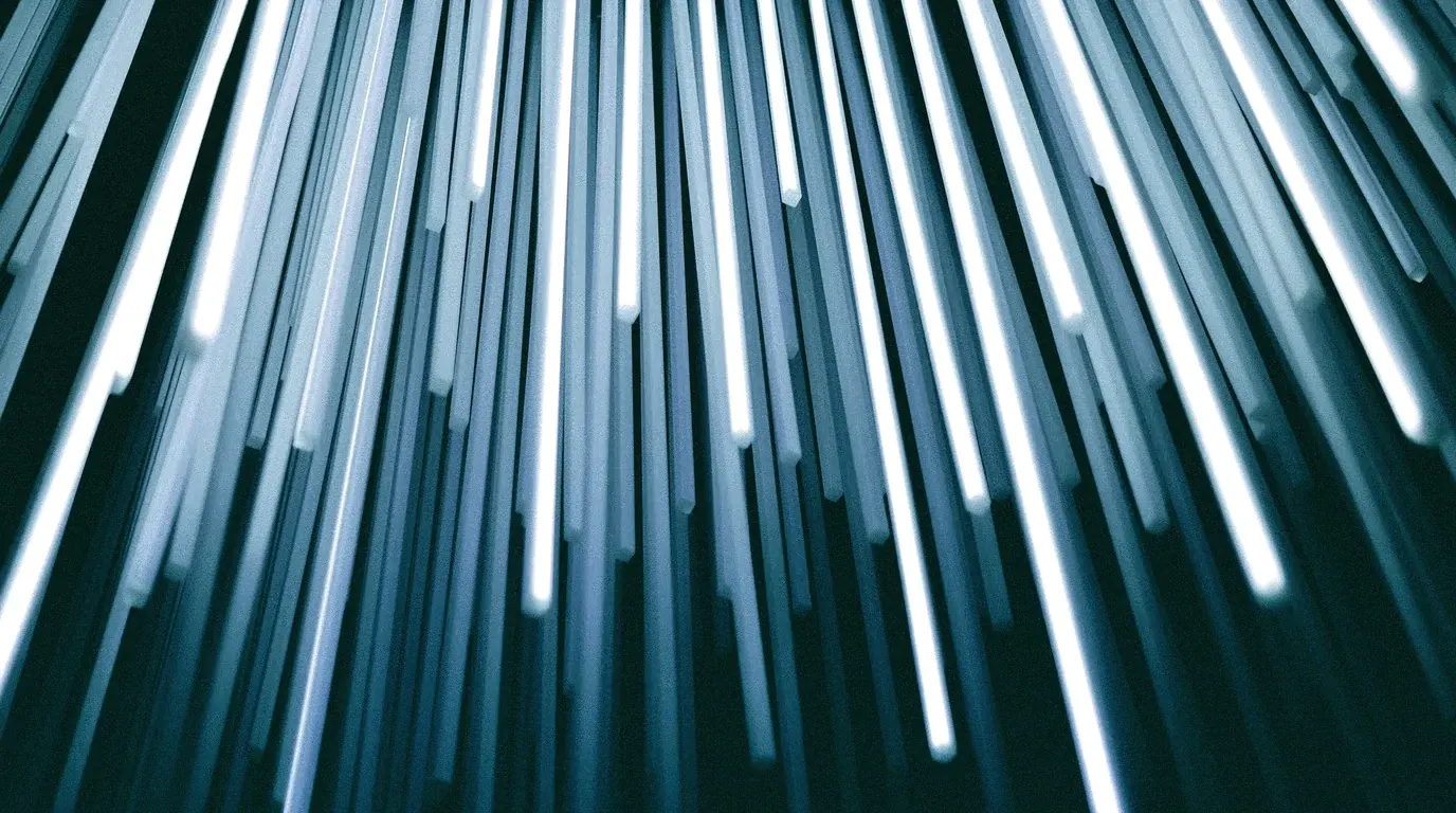 Strands of optical fibre glowing with light, fanning out from the bottom of the frame.